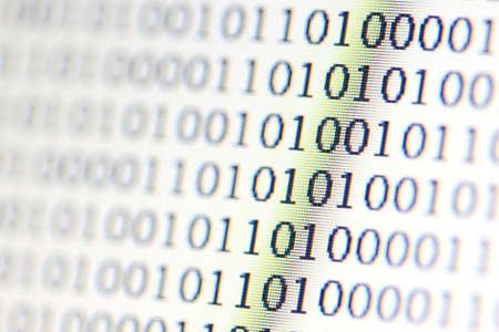 0,1, binary code on LED computer monitor の写真素材