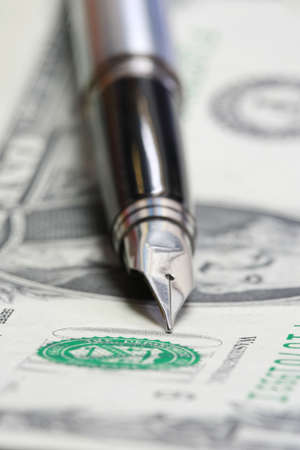 Metal Nib Pen on dollar billの写真素材