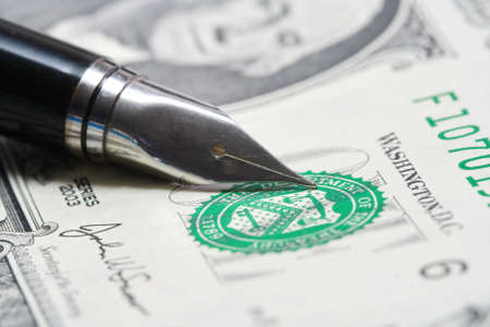 Metal Nib Pen on dollar billの写真素材