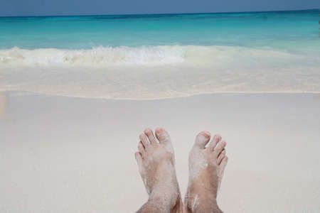 barefoot on sand beachの写真素材