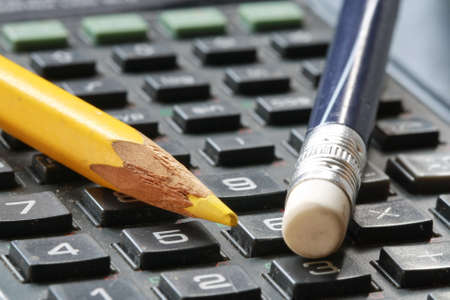 eraser and pencil on calculator の写真素材