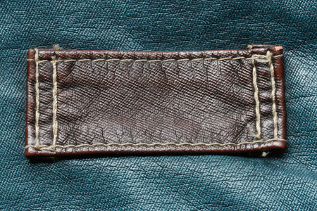 brown leather tag on green の写真素材