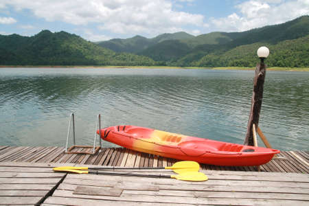 Red kayak with mountain and lake の写真素材