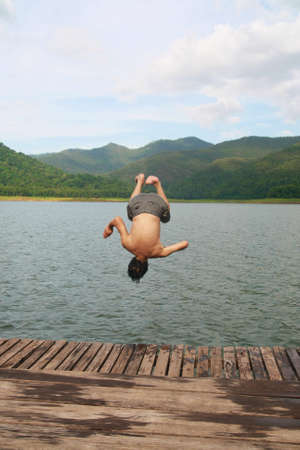 a man jump to river の写真素材