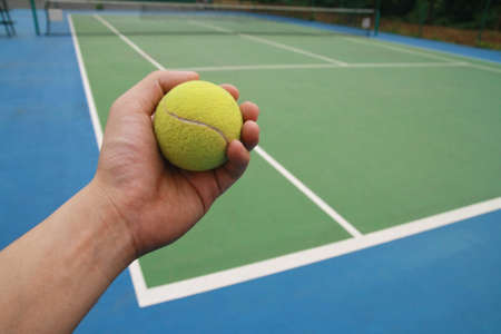 tennis ball on player handの写真素材