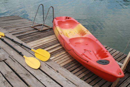 Red kayak on wood floor の写真素材
