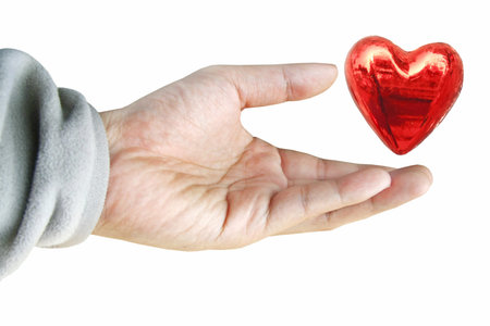 Hand holding red heart 