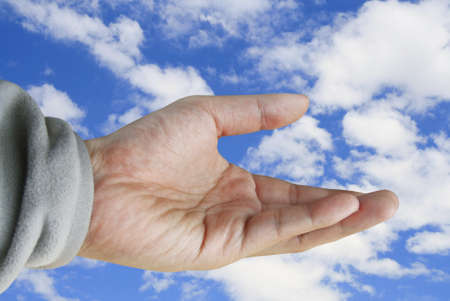 human hand holding on summer sky の写真素材