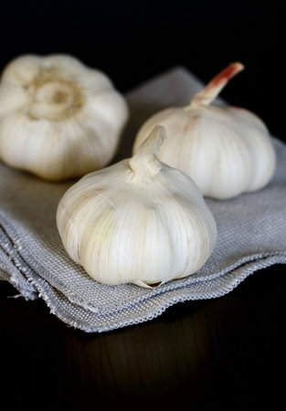 Garlic on fabric , black table