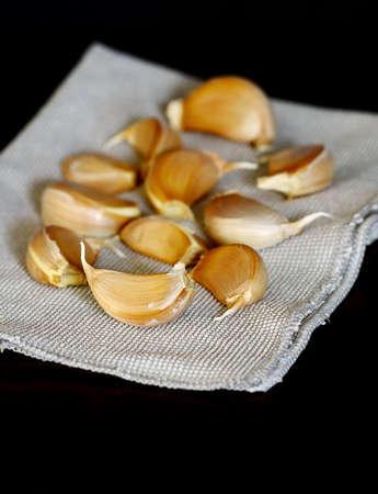 Garlic  on fabric ,black tableの写真素材
