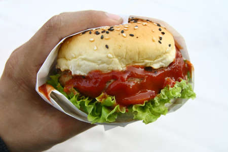 hand hold hamburger on whiteの写真素材