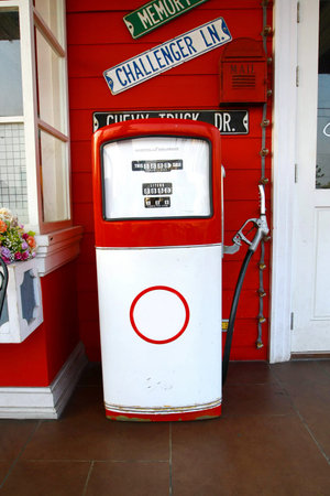 red vintage gasoline pump over white