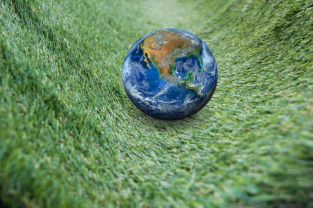 the earth on green grassの写真素材