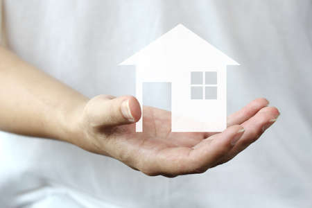hand holding a house backgroundの写真素材