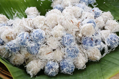 Thai dessert with coconut slide on banana leaveの写真素材