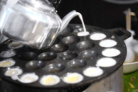 A man is cooking Kanom Krok , Dessert Thai sweet. Thai coconut pudding, Thai sweetの写真素材
