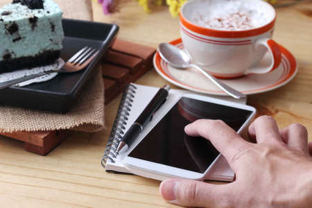 notebook pen and coffee cup with cake and cookie, cafeの写真素材