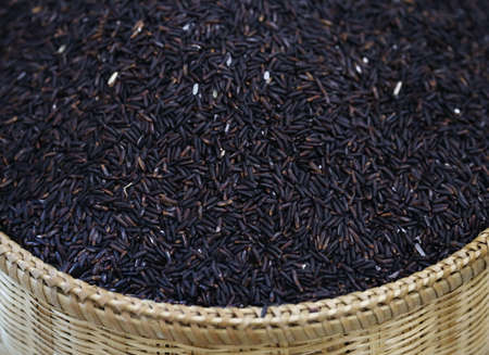 closeup raw organic rice in basketの写真素材