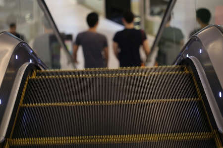 escalator with shopping man backgroundの写真素材
