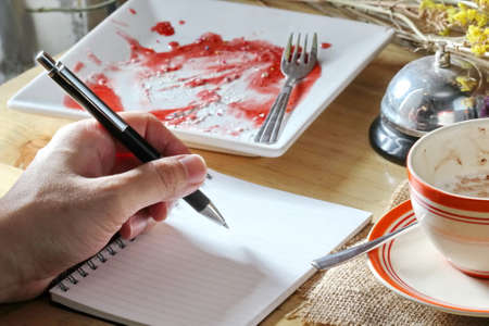 hand with coffee cup and notebookの写真素材