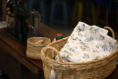 fabric in basket near sewing machineの写真素材