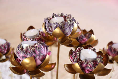 candle in golden lotusの写真素材