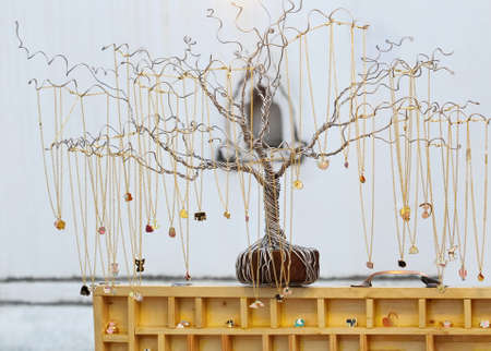 gold necklace on steel treeの写真素材