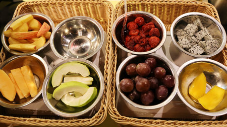 dragon fruit ,grapes ,peach, mango, strawberry on metal bowlの写真素材