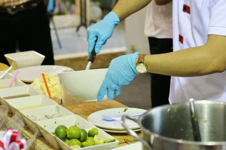 chef hand cooking spicy saladの写真素材