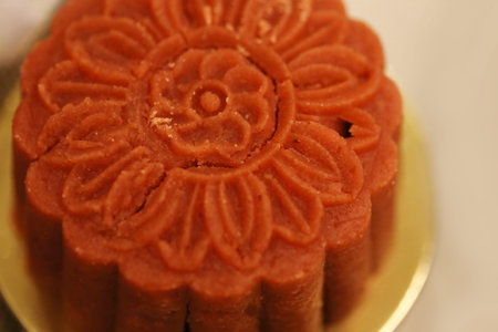 Retro vintage style Chinese mid autumn festival foods. Traditional mooncakes on table setting with...