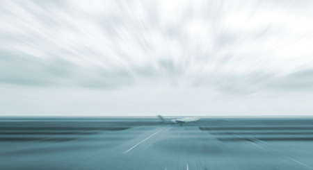 motion blurred airplane on runway, monotone backgroundの写真素材