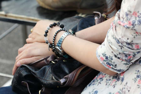 blurred women hand hold bag on leg, backgroundの写真素材