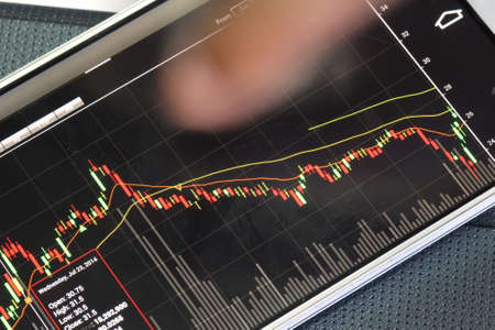 smartphone and stock chart investment trading backgroundの写真素材
