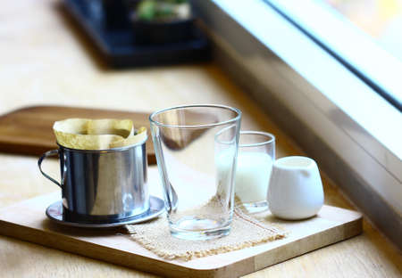 coffee dripping in vietnamese style on wooden tableの写真素材