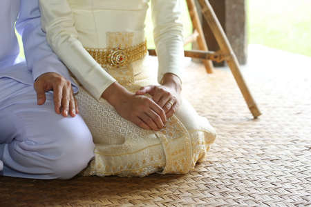 lover hold hand with gold wedding ring, Thai dressの写真素材