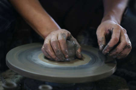 Hands working on pottery wheelの写真素材