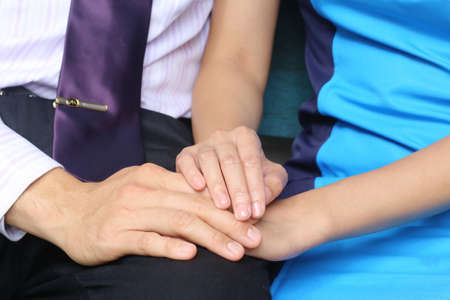 businessman and businesswomen hold hand with ringの写真素材