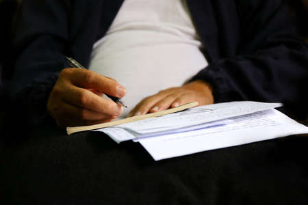 man write pen on document paperの写真素材