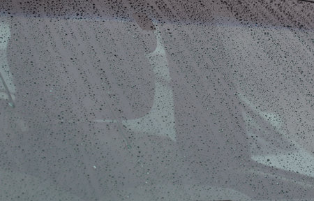 rain drops on car glass in rainy days, background