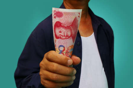 businessman holding yuan RMB in his handsの写真素材