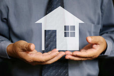 businessman use two hand hold house graphicの写真素材
