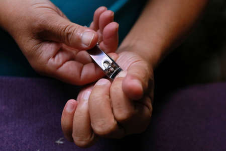 closeup of a man cutting nailsの写真素材