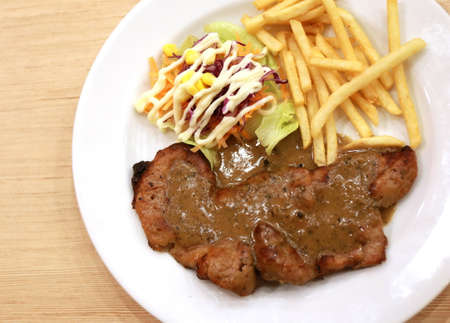 pork stake with french fried on plateの写真素材
