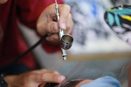 hand air brush coloring to body paintの写真素材