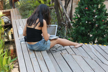 women using laptop in outdoor parkの写真素材