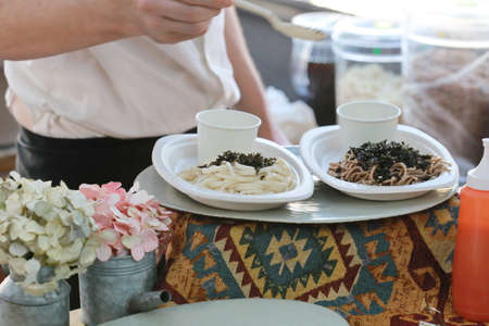 hand and white spaghetti on tableの写真素材