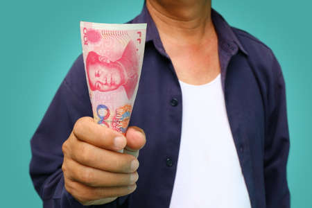 businessman holding yuan RMB in his handsの写真素材