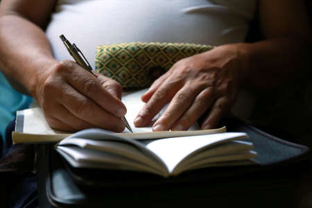 man writing on document paperの写真素材