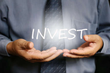 Invest word on hand, businessmanの写真素材
