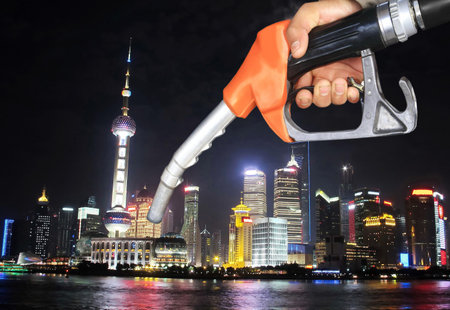 oil pump nozzle and night city view, Shanghai, Chinaのeditorial素材